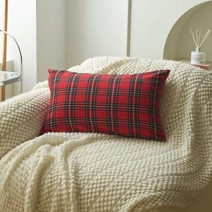 Red Christmas plaid lumbar pillow cover on soft knit blanket for home decor