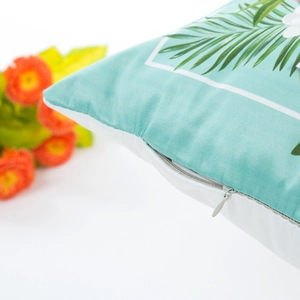 Faux silk pillow cover with tropical palm leaf print and white floral patterns