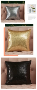 Detail of shimmering silver, gold, and black sequin pillow covers on a pink sofa