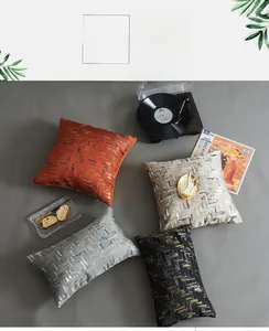 Close-up of luxury geometric jacquard pillow covers with metallic texture and modern patterns