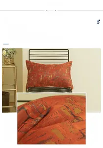 Detail of terracotta geometric jacquard pillowcase showing frosted texture and golden threads