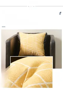 Close-up of yellow chenille cushion cover with white abstract geometric line patterns