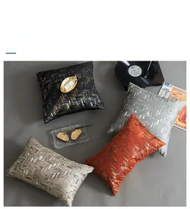 Detailed close-up of high-density jacquard pillow covers with geometric metallic patterns