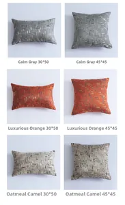 Detail view of jacquard cushion covers in grey orange and camel with metallic texture