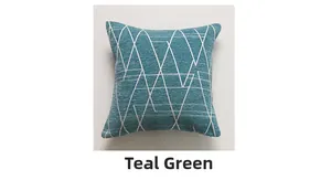 Detail of aqua green chenille pillow cover featuring white geometric triangle patterns