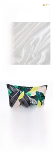 Detail of soft faux silk pillowcase featuring green tropical leaves and yellow dots