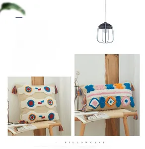 Close-up of tufted bohemian pillow covers with colorful patterns and handmade tassels