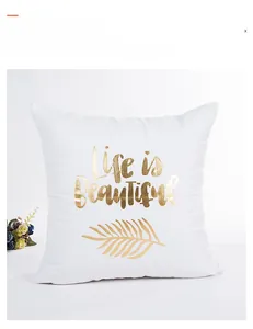 Detail of white Easter pillow cover featuring gold foil Life is Beautiful and palm leaves