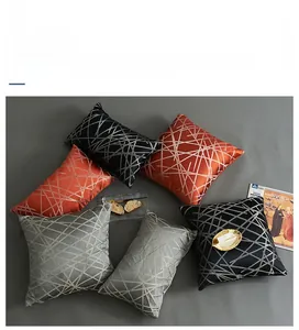 Close-up of luxury jacquard pillowcases with golden geometric stripes and satin texture