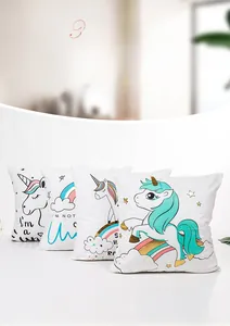 Detail of four unicorn pillow covers with gold foil rainbow and star patterns