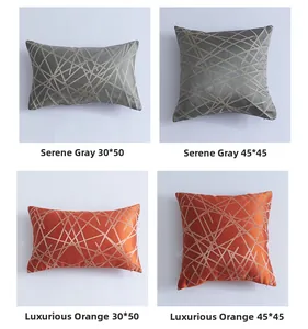 Detail of luxury geometric striped jacquard pillowcase in grey and orange satin fabric