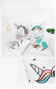 Detail of soft fabric and colorful unicorn gold foil print on a white decorative pillowcase