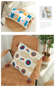 Detail of bohemian tufted pillow covers with colorful tassels and geometric textures