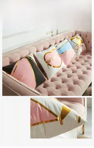 Detail of pink geometric cushion cover with gold foil accents and soft texture