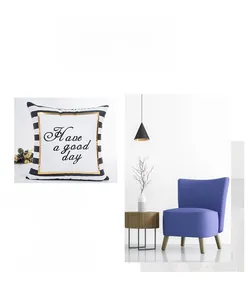 Detail of striped pillow cover with gold trim and Have a good day text in a modern living room