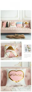 Detail of pink and gold decorative cushion covers with heart patterns and foil prints