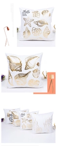 Close-up of gold foiled ocean patterns like shells and starfish on white pillowcase