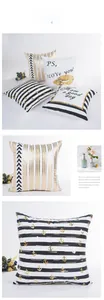 Detail of modern striped pillow cover with gold foil heart and anchor patterns