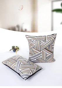 Detail view of gray and gold geometric striped pillow cases with zipper closure