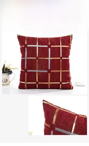 Close-up of deep red chenille cushion cover with metallic gold and silver grid pattern