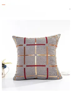 Close-up of gray chenille cushion cover featuring gold foil geometric plaid pattern