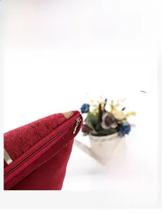 Close-up of invisible zipper detail on red chenille cushion cover with high-density stitching