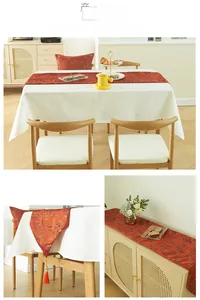 Detail of modern table runner with orange geometric patterns and elegant tassels