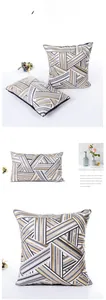 Detail of geometric pillow covers with gold foil stripes in square and lumbar styles