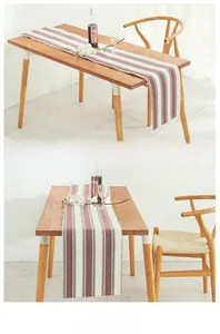 Detailed texture of cotton linen striped table runner on light wood dining table