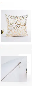 Detail of invisible zipper and gold coral pattern on modern white cushion cover