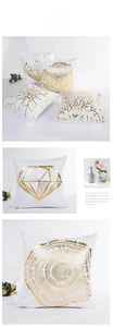 Detail of gold foil branch and floral patterns on white modern decorative cushion covers