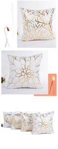 Detail of white pillow covers with gold foil branch and floral patterns on soft fabric