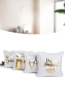 Detail of white plush pillow covers with gold foil Love and Life is Beautiful lettering