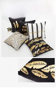Detail of gold feather print on black and white luxury velvet cushion covers