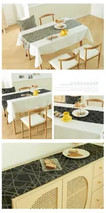Detail of modern table runner with geometric gold lines and elegant fringe tassels