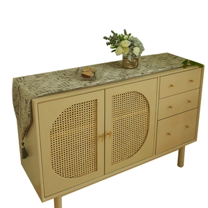 Modern geometric mosaic table runner with tassels on a vintage sideboard display
