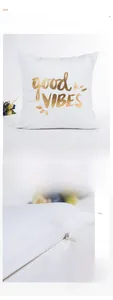 Detail of white velvet pillow cover with gold foil lettering and hidden zipper closure