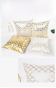 Detail of white velvet pillow covers with gold foil geometric diamond and wave patterns