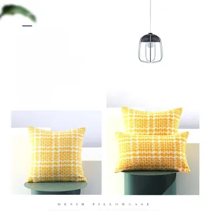 Close-up of yellow denim waffle weave texture on square and rectangular pillowcases
