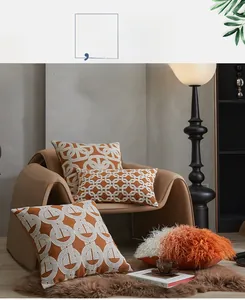 Detail of geometric embroidered pillow covers in caramel orange with 3D embroidery textures