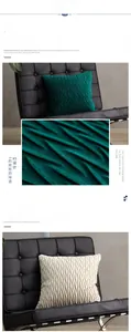 Close-up of pleated velvet cushion covers in emerald green and cream white luxury fabric