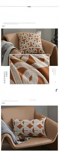 Detailed texture of orange geometric jacquard cushion cover on a leather chair