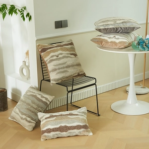 Luxurious faux fur pillow covers with wavy textures in beige, grey, and brown tones