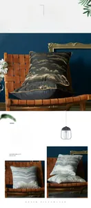 Detail of luxury geometric cushion cover with mountain pattern and golden piping