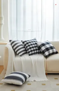 Detail of minimalist black and white checkered cushions with woven poly-cotton texture
