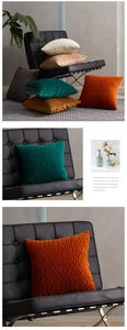 Detail of geometric pleated velvet pillow covers in orange, green, beige and grey colors