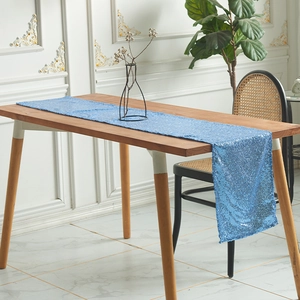 Elegant blue sequin table runner for modern party decor on wooden dining table