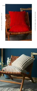 Close-up of thick plush decorative pillow with vertical striped texture in red and cream