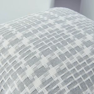 Two-tone woven decorative pillow cover featuring a grey and white minimalist textured pattern
