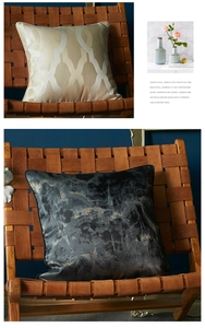Detail of luxury geometric gold and marble pattern throw pillow covers on a leather chair